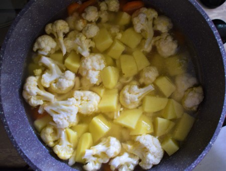 Vegetables simmering to make creamy cauliflower soup