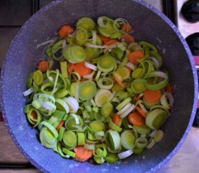 Carrots and leeks sauteed in a pot