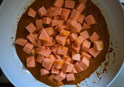 Sweet potato cubes cooking into spiced tomato gravy