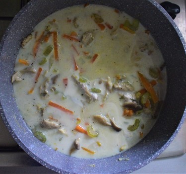 Simmering soup with veggies and soy milk