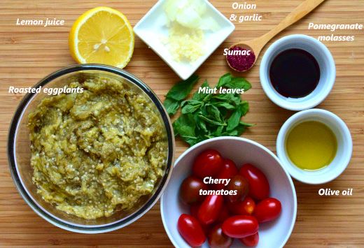 Baba ganoush ingredients: roasted eggplants, tomatoes, olive oil, pomegranate molasses, onion, garlic, mint, lemon juice, sumac