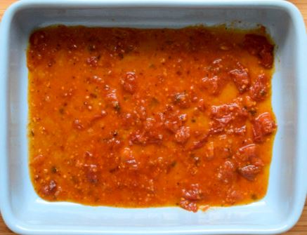 Marinara sauce layer on the bottom of the baking dish